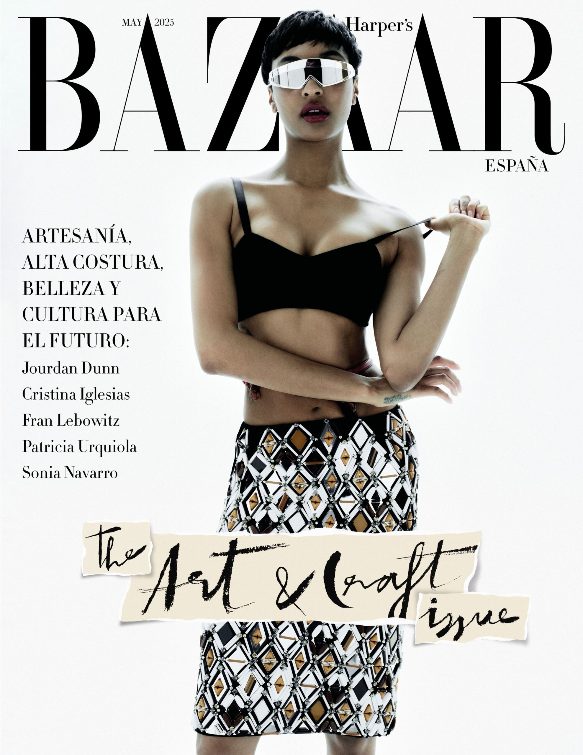 Jourdan Dunn posing in a graphic-patterned skirt and futuristic sunglasses for Harper’s Bazaar España