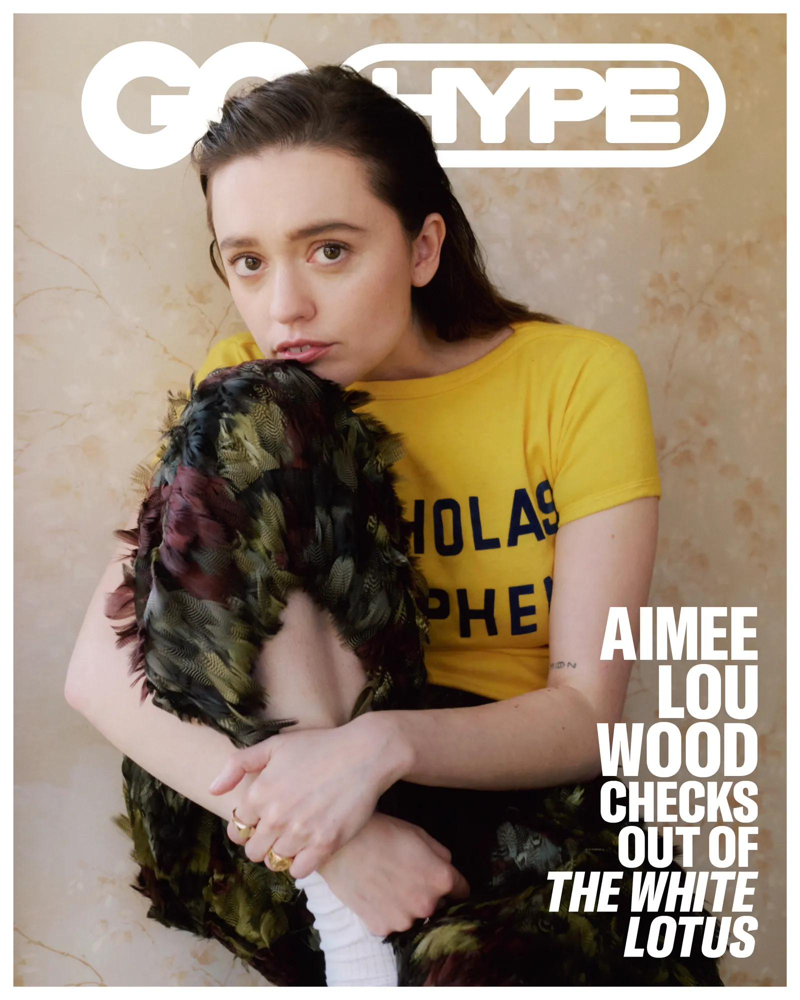 GQ Hype cover featuring Aimee Lou Wood in a yellow Nicholas Shepherd T-shirt and feathered pants, sitting with a thoughtful expression.