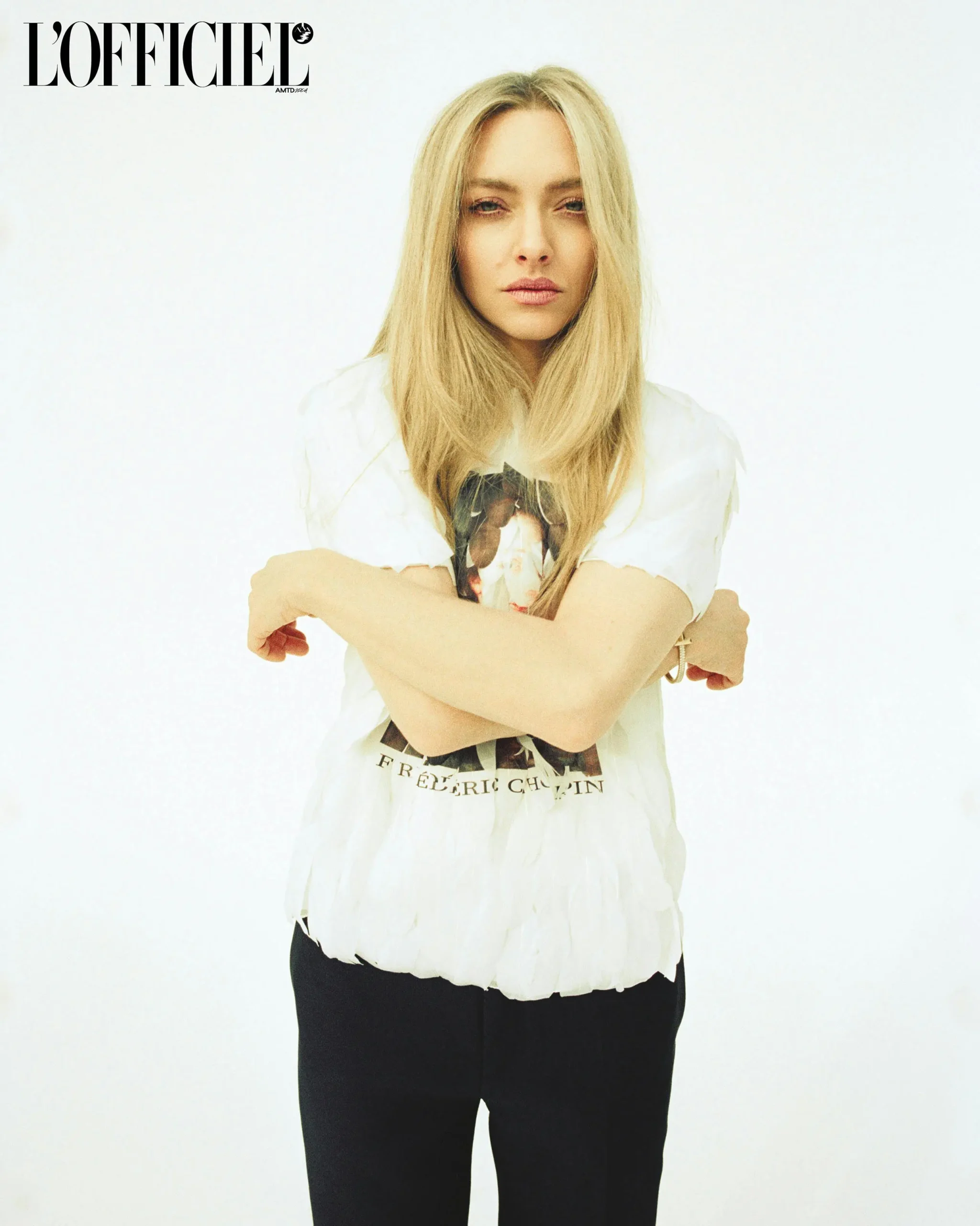 Amanda Seyfried wearing a printed white shirt and black trousers in a minimalist studio shoot for L’Officiel Spring 2025