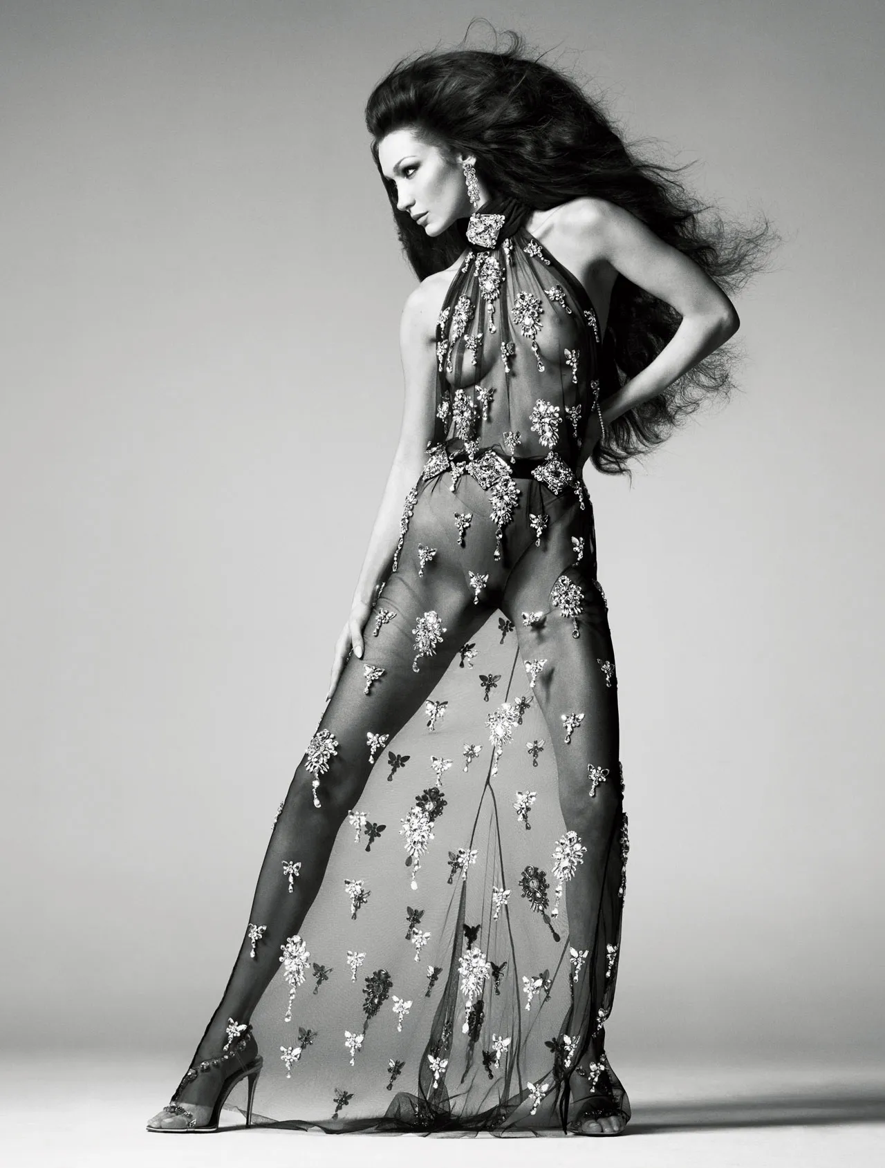 Bella Hadid wearing a sheer embroidered gown adorned with jewel-like florals, exuding elegance and confidence in British Vogue June 2025.