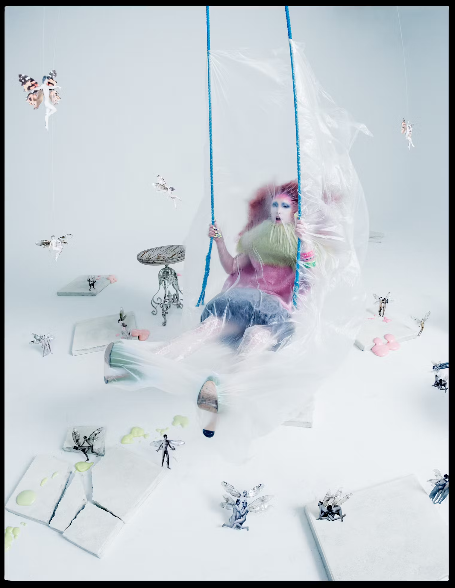 Wrapped in translucent plastic, Chappell Roan swings in a surreal fairyland set, wearing pastel tones and voluminous textures – part of W Magazine's fantasy-themed May 2025 shoot.