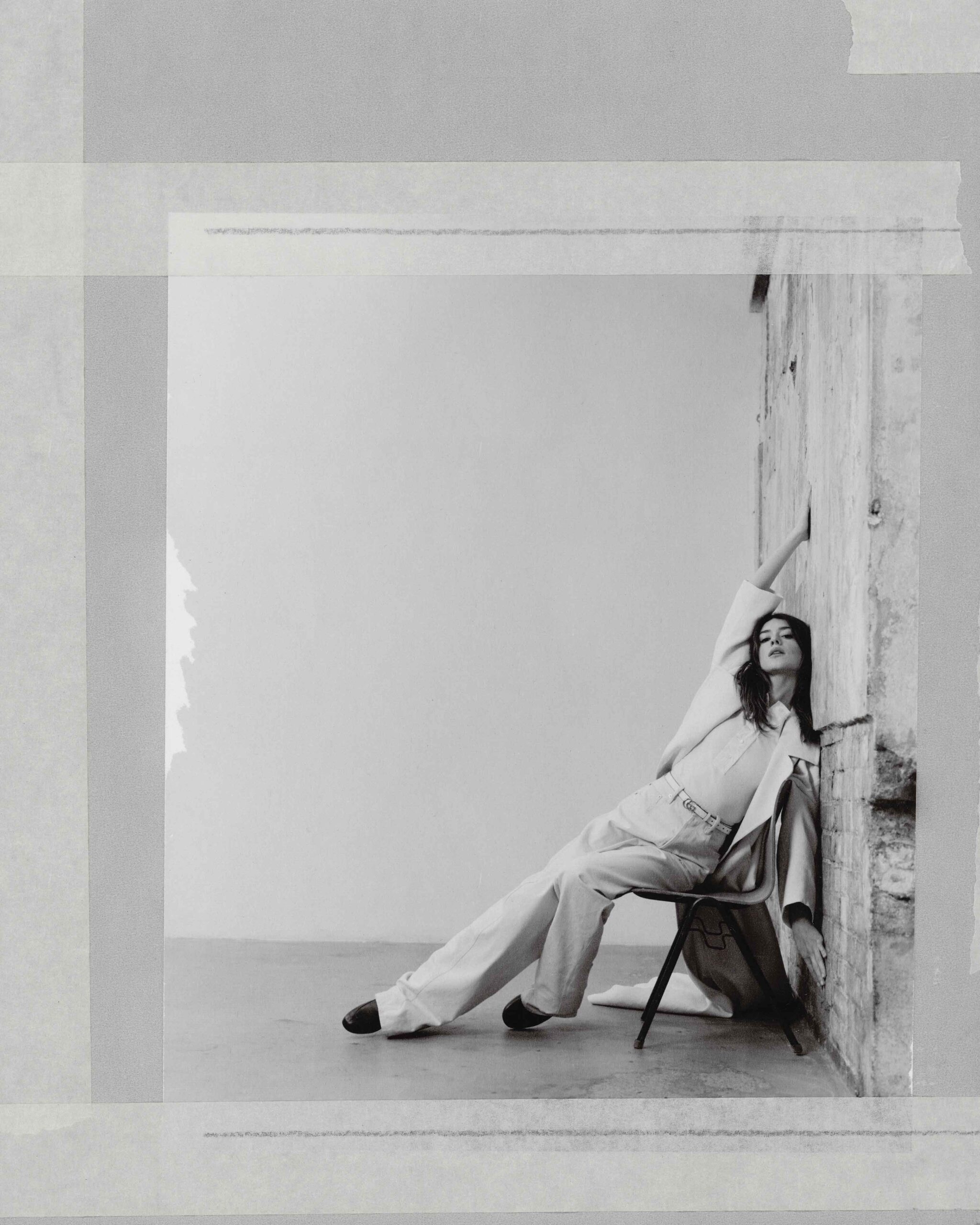 Daisy Edgar-Jones poses in a cream pantsuit, leaning back dramatically against a studio wall for Flaunt Magazine April 2025.