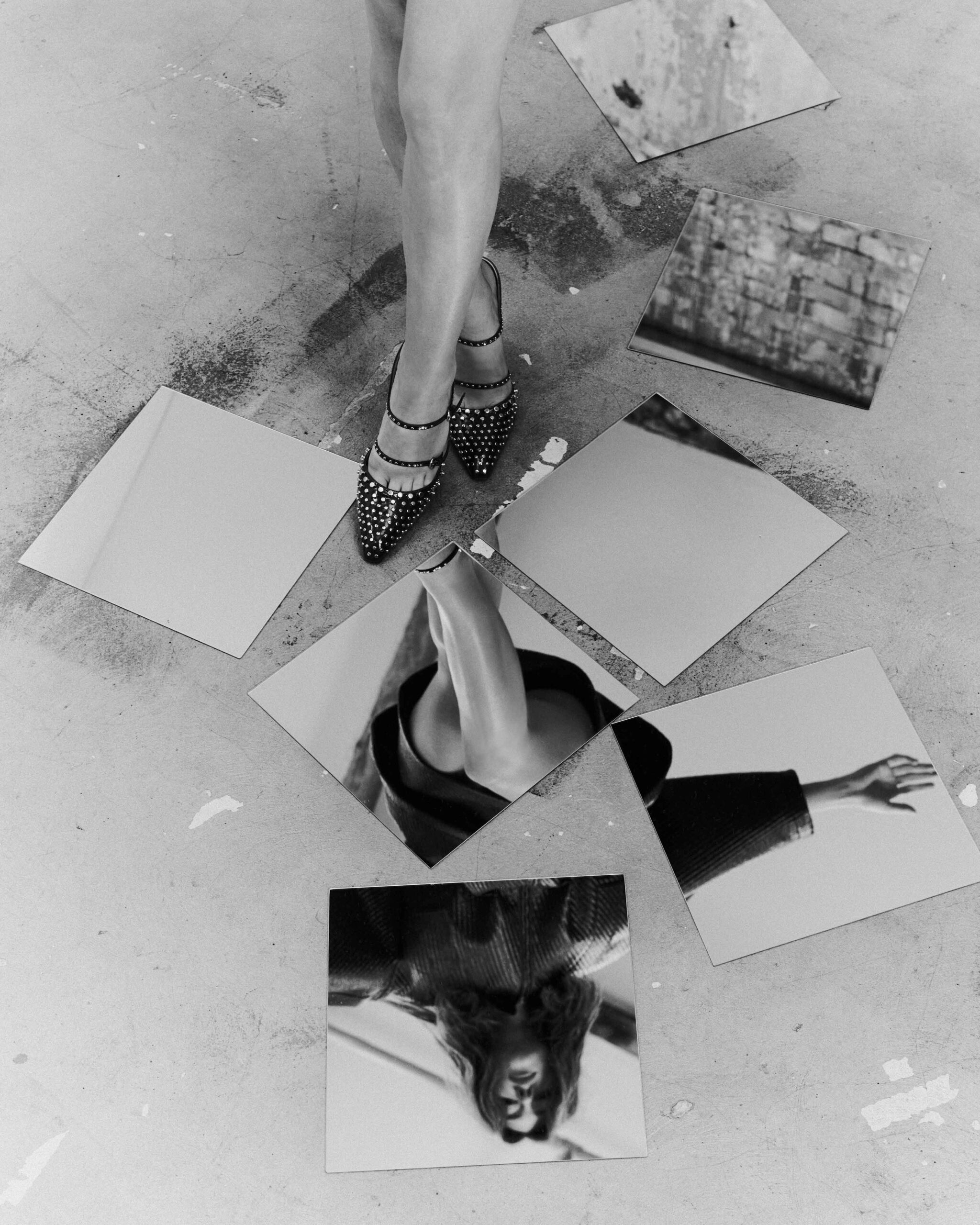 High-concept photo of Daisy Edgar-Jones with shattered mirror reflections on the floor, showcasing studded heels for Flaunt April 2025.