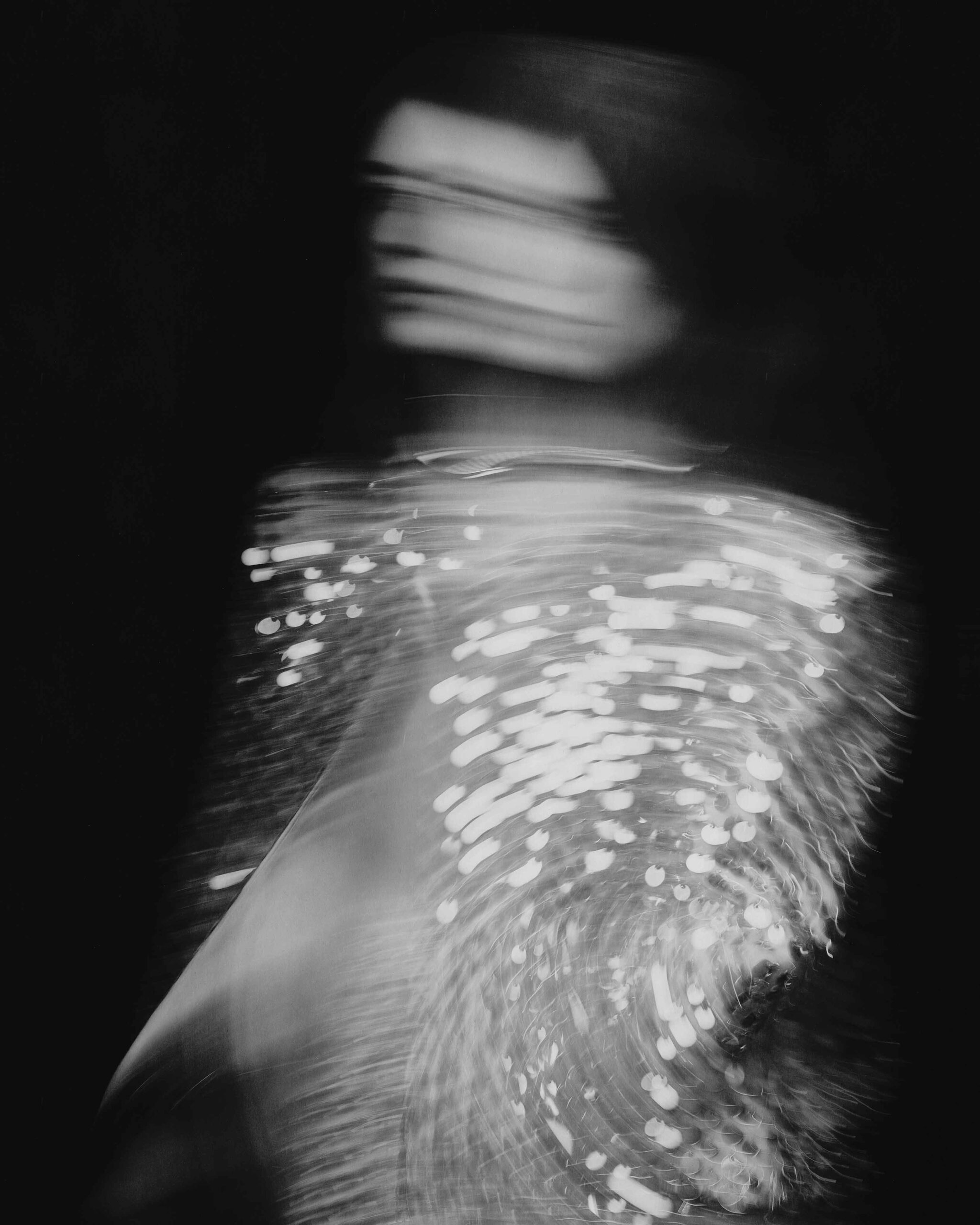 Abstract black-and-white close-up of Daisy Edgar-Jones in sequins with intense motion blur and light trails, Flaunt Magazine April 2025.