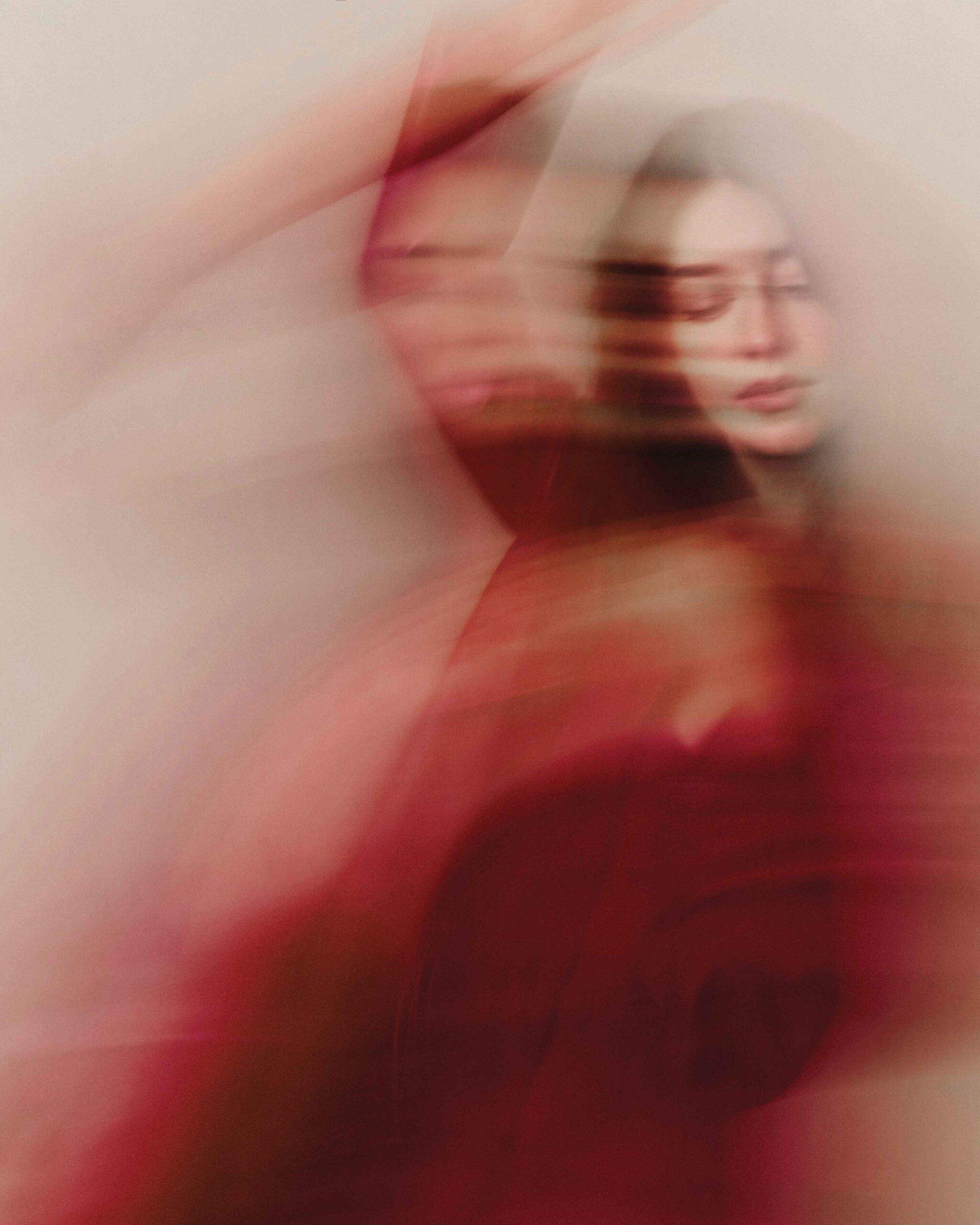 Artistic motion-blur portrait of Daisy Edgar-Jones in a red dress for Flaunt Magazine April 2025 issue.