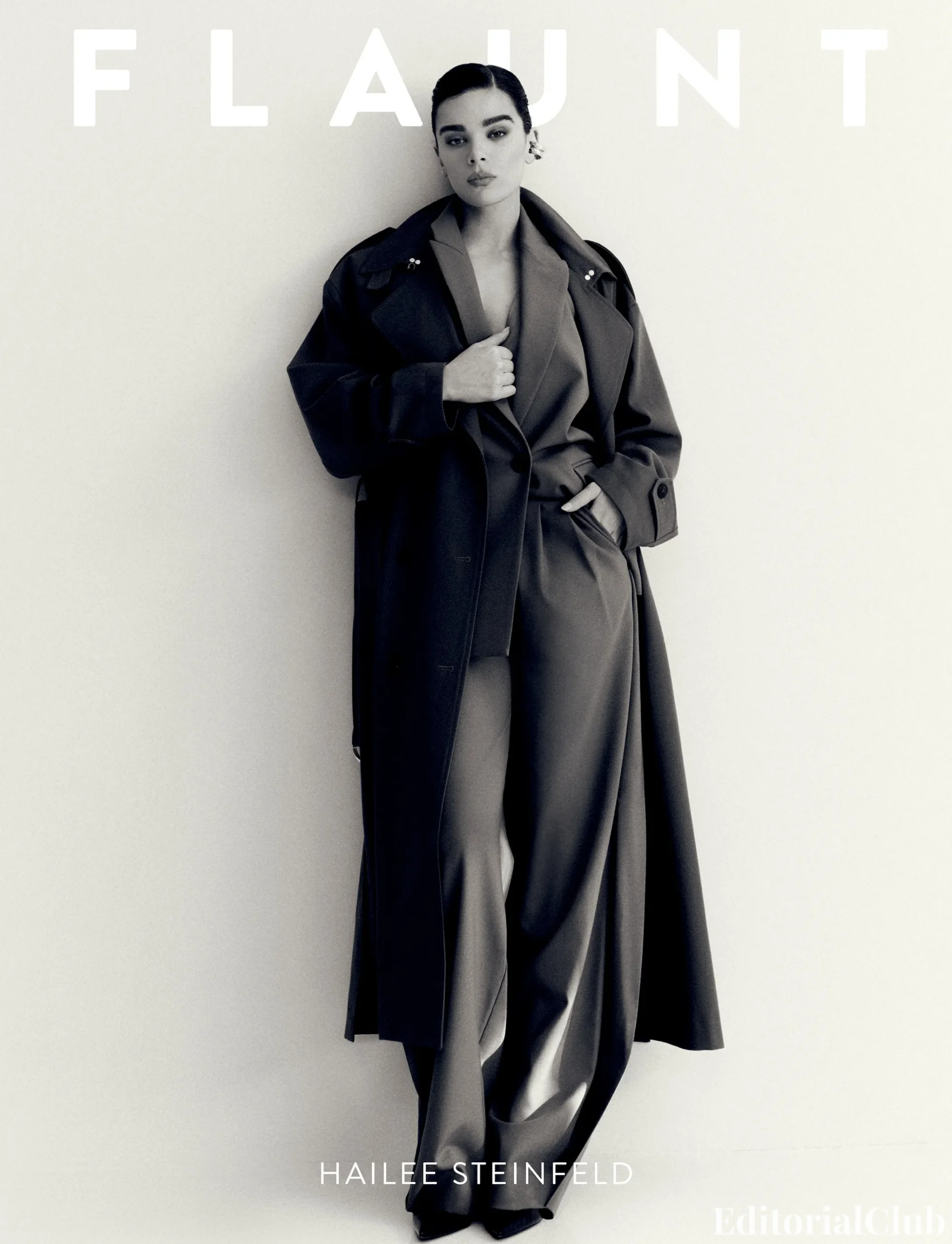 Hailee Steinfeld poses in an oversized coat and wide-leg suit for Flaunt Magazine March 2025 cover shoot.