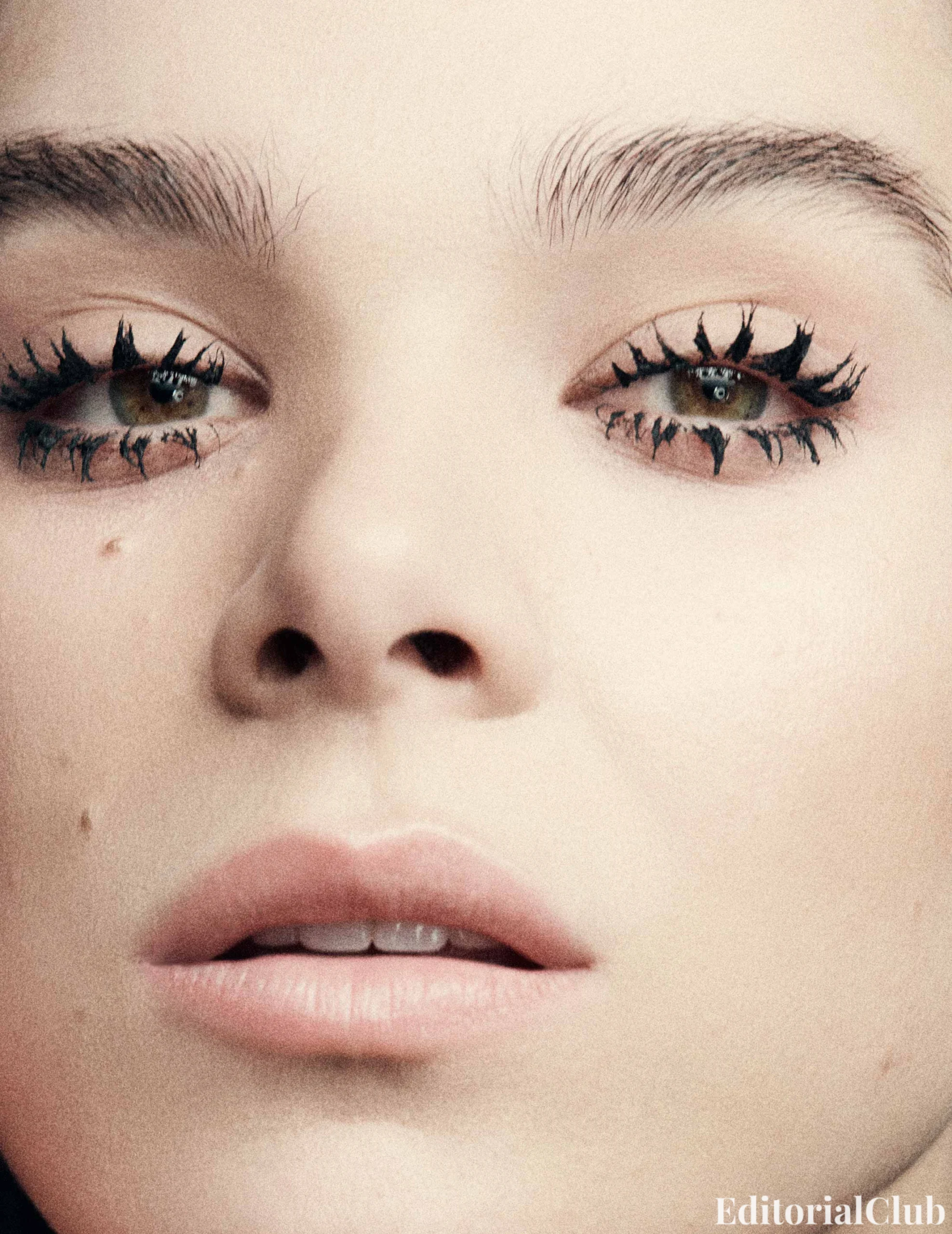 Extreme close-up of Hailee Steinfeld’s face with graphic spider lash mascara, featured in Flaunt March 2025.