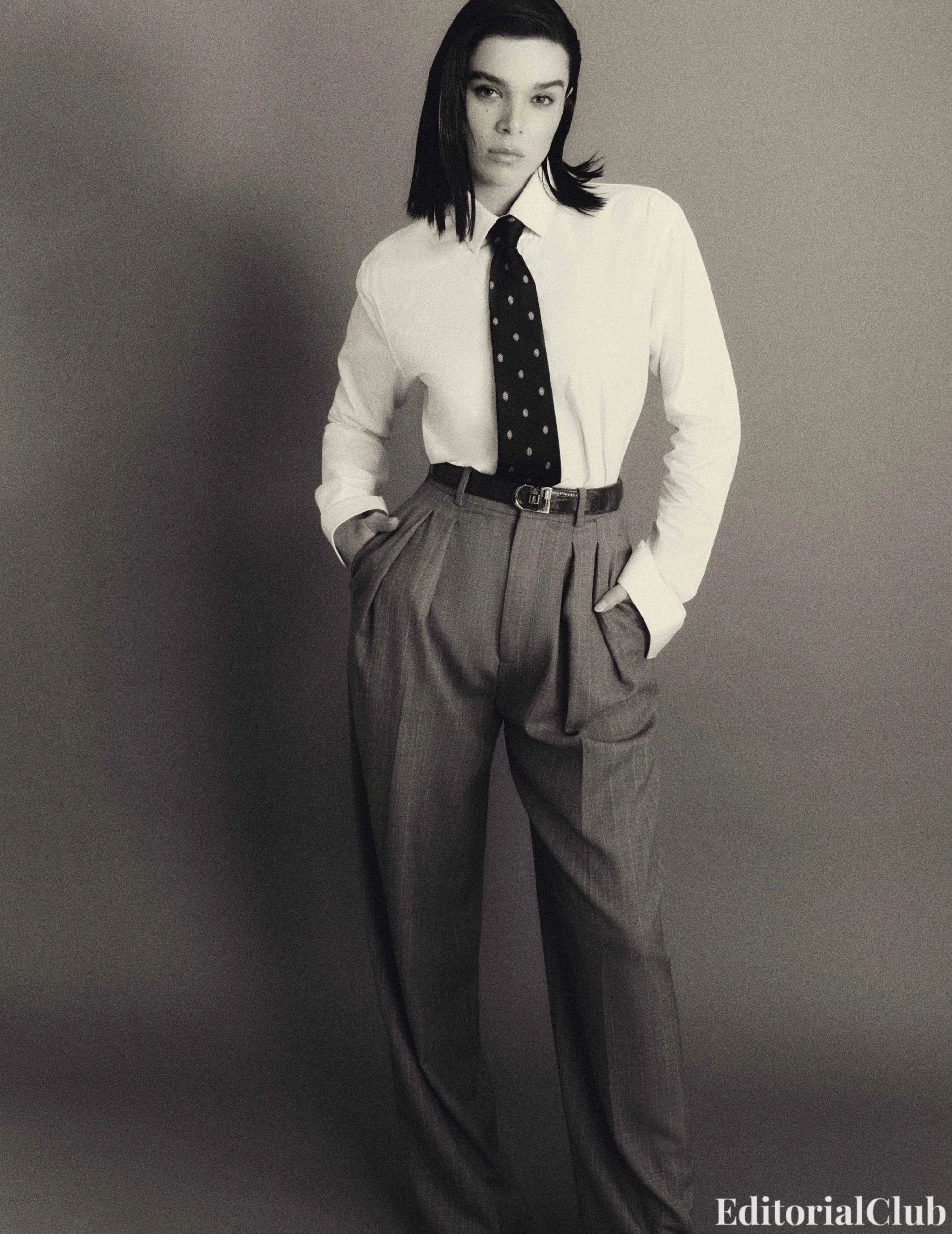 Hailee Steinfeld styled in a white shirt and polka dot tie, channeling masculine chic in Flaunt Magazine.