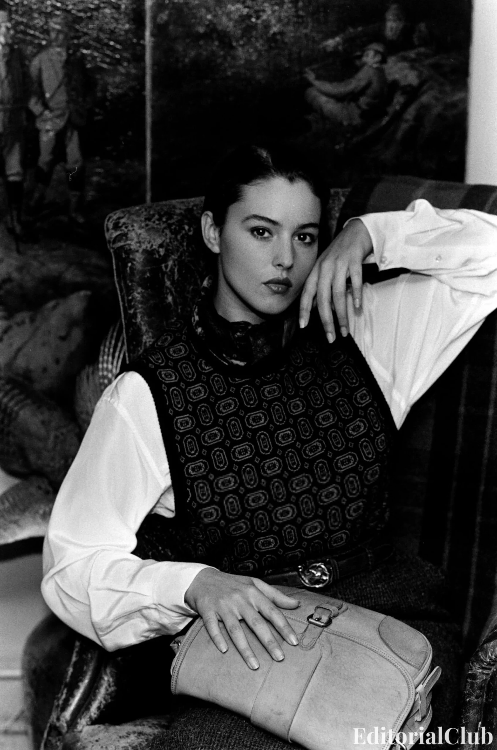 Monica Bellucci in Ralph Lauren Fall 1989, wearing Western-inspired layers including a plaid shirt, embroidered gloves, wide-brim hat, and belted corduroy trousers, and a tailored look with a printed knit vest over a collared blouse styled with a belt and shoulder bag.