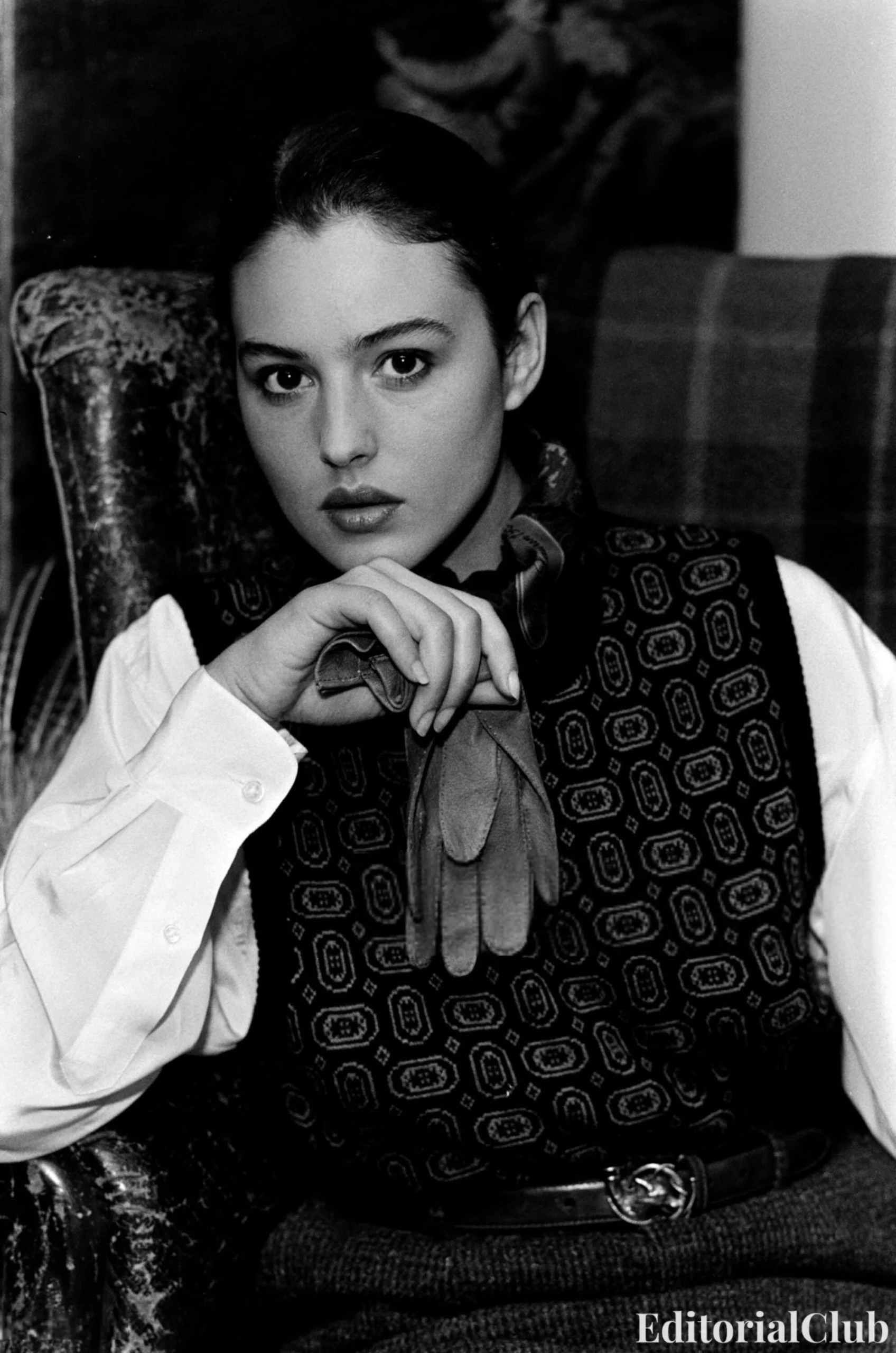 Monica Bellucci in Ralph Lauren Fall 1989, wearing Western-inspired layers including a plaid shirt, embroidered gloves, wide-brim hat, and belted corduroy trousers, and a tailored look with a printed knit vest over a collared blouse styled with a belt and shoulder bag.