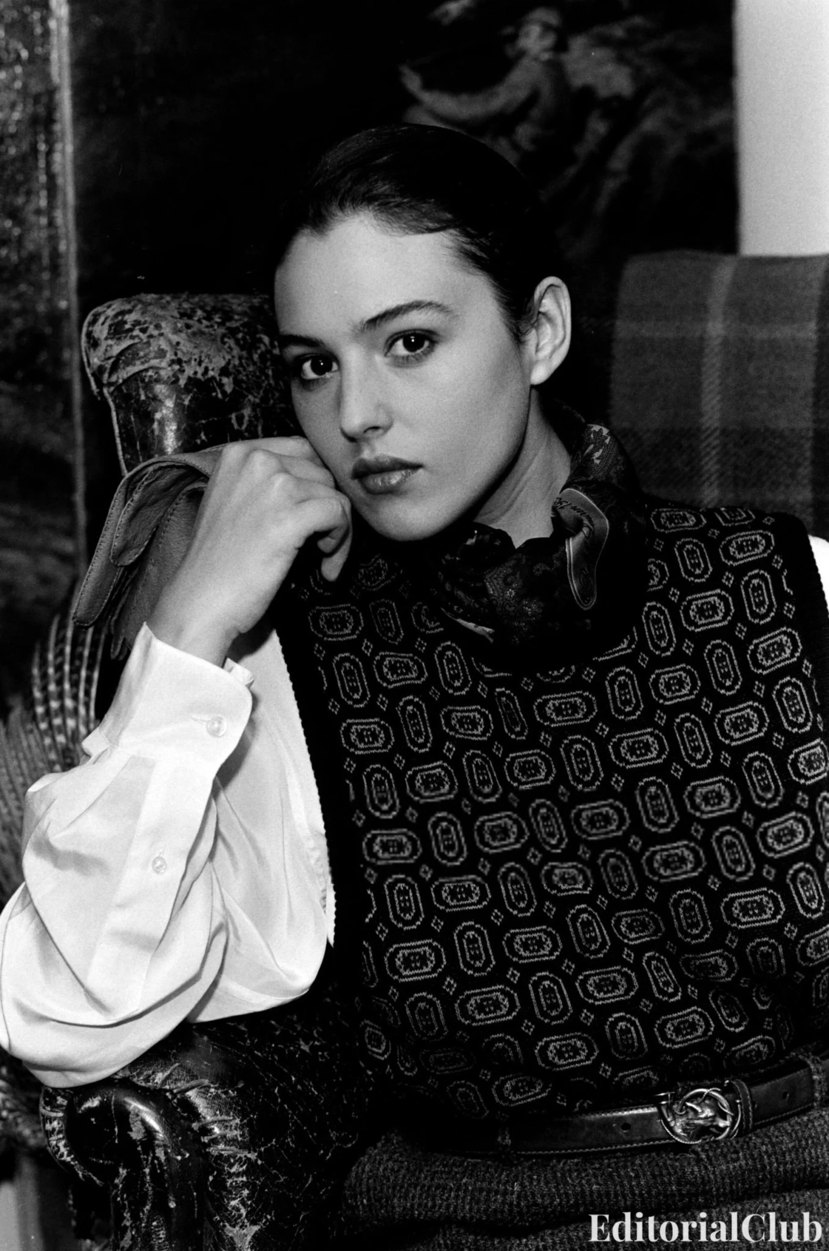 Monica Bellucci in Ralph Lauren Fall 1989, wearing Western-inspired layers including a plaid shirt, embroidered gloves, wide-brim hat, and belted corduroy trousers, and a tailored look with a printed knit vest over a collared blouse styled with a belt and shoulder bag.