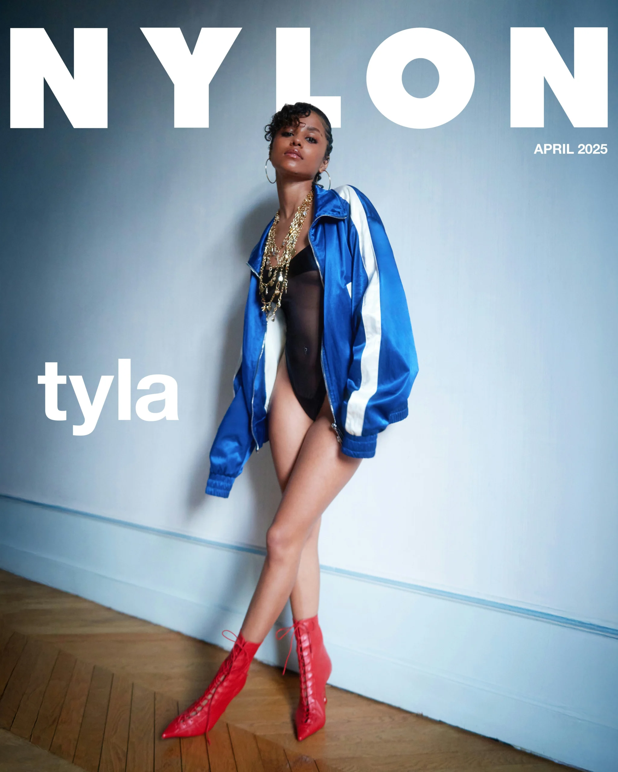 Tyla on Nylon cover wearing blue jacket and red lace-up boots, April 2025